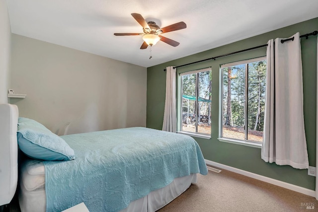 bedroom featuring carpet flooring, a ceiling fan, and baseboards