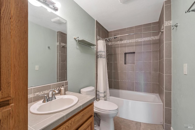 full bath with toilet, tile patterned floors, shower / bath combo with shower curtain, and vanity