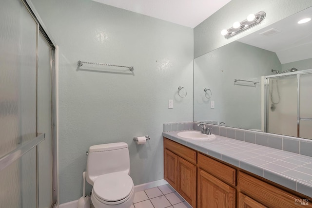 bathroom featuring baseboards, toilet, tile patterned floors, an enclosed shower, and vanity