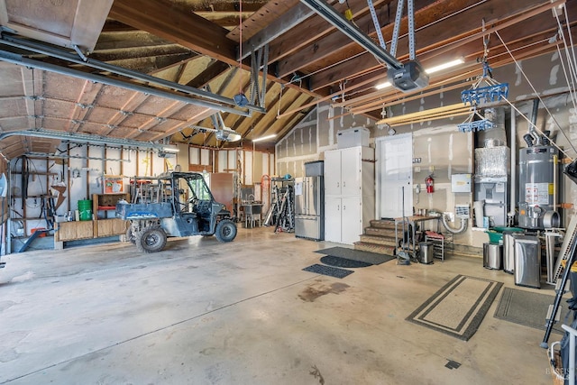 garage with strapped water heater, high end refrigerator, heating unit, and a garage door opener