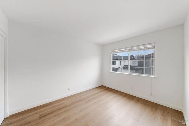 unfurnished room featuring light wood-style floors and baseboards