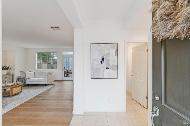 foyer entrance with visible vents and light wood-style flooring