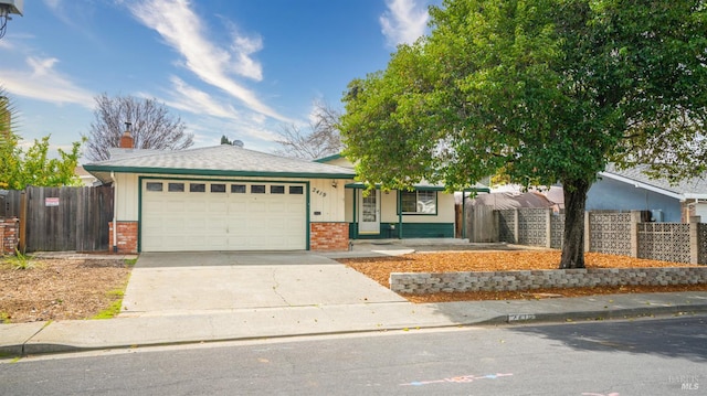 ranch-style home featuring a garage, brick siding, fence, concrete driveway, and a chimney