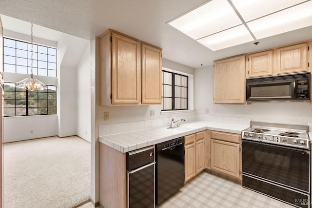 kitchen with a chandelier, a sink, black appliances, and light brown cabinetry