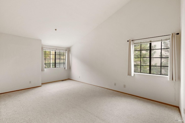 unfurnished room featuring high vaulted ceiling, carpet, and baseboards