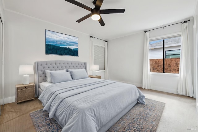 bedroom with baseboards, a ceiling fan, and light colored carpet