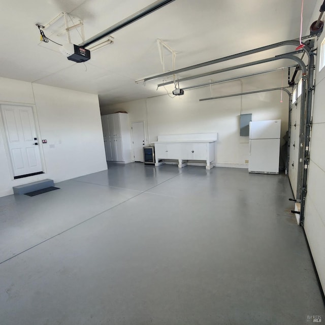 garage featuring a garage door opener and freestanding refrigerator