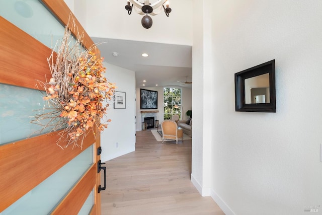 hallway with recessed lighting, baseboards, and light wood-type flooring