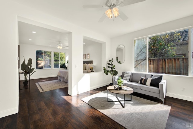 living area featuring a ceiling fan, recessed lighting, dark wood finished floors, and baseboards