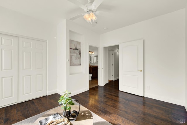 unfurnished living room featuring ceiling fan, dark wood-style flooring, and baseboards