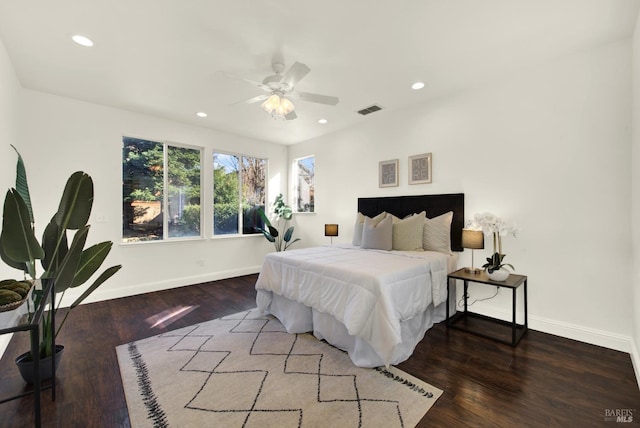 bedroom with baseboards, wood finished floors, visible vents, and recessed lighting