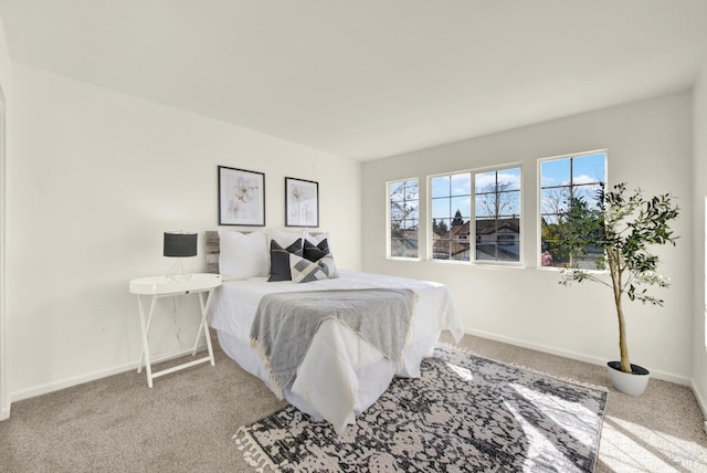 bedroom with carpet floors and baseboards