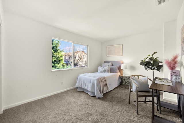 carpeted bedroom with visible vents and baseboards