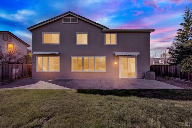 back of house featuring a patio, a yard, a fenced backyard, and stucco siding