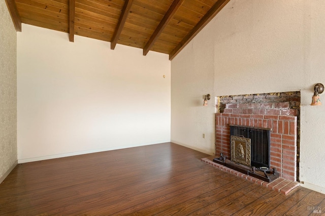 unfurnished living room featuring baseboards, lofted ceiling with beams, wooden ceiling, dark wood-style flooring, and a brick fireplace