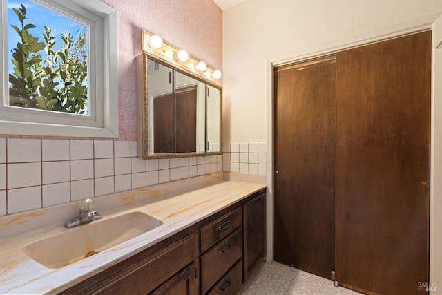 bathroom featuring vanity and decorative backsplash