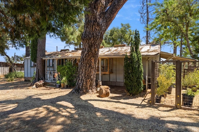 rear view of house featuring fence