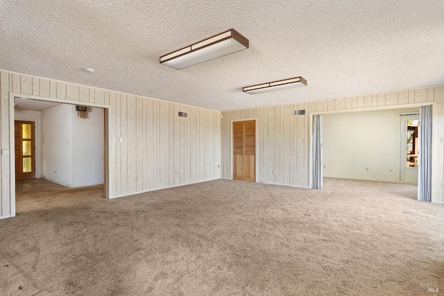 1579 Leslie Ln, Kelseyville, CA 95451 - carpeted spare room with a textured ceiling and wood walls