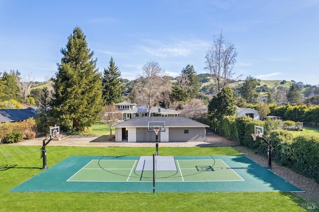 view of basketball court with a lawn, a mountain view, and basketball court