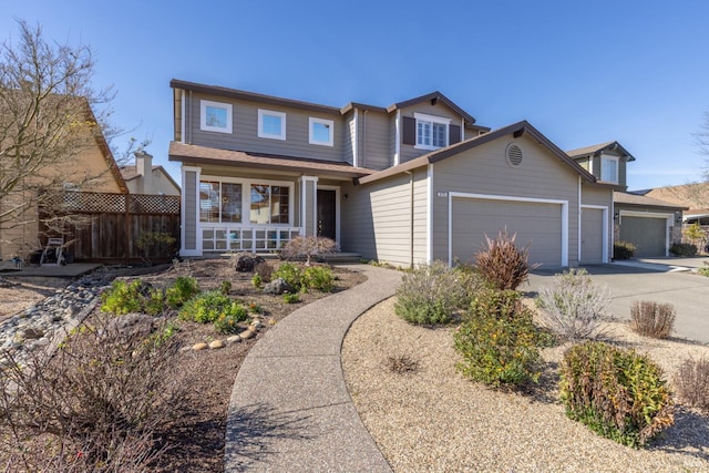 view of front of property featuring covered porch, concrete driveway, fence, and a garage