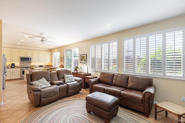 living room featuring light tile patterned flooring, a ceiling fan, and recessed lighting