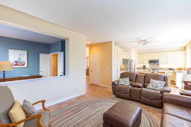 living room featuring recessed lighting, baseboards, a ceiling fan, and light tile patterned flooring