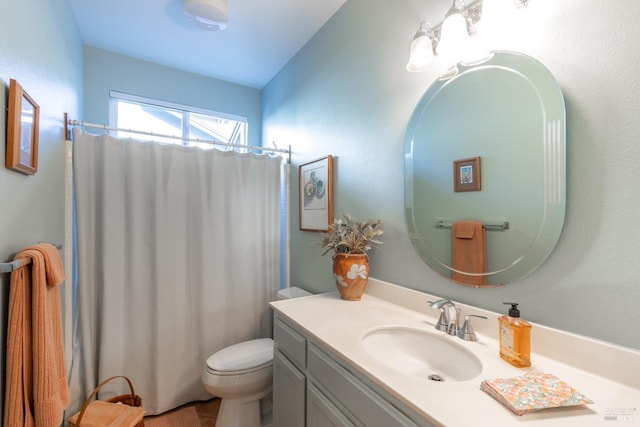 bathroom with toilet, curtained shower, and vanity