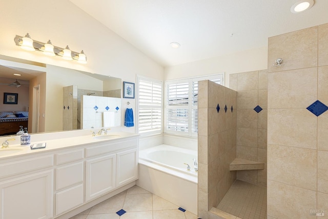 ensuite bathroom with ensuite bathroom, a walk in shower, a sink, and tile patterned floors