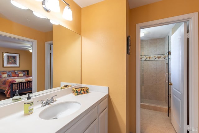 ensuite bathroom featuring a stall shower, tile patterned flooring, ensuite bathroom, and vanity