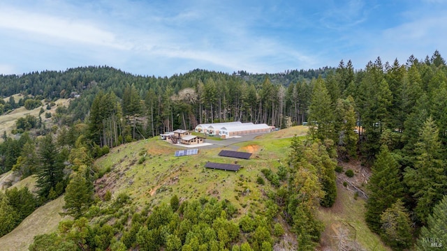 birds eye view of property with a wooded view