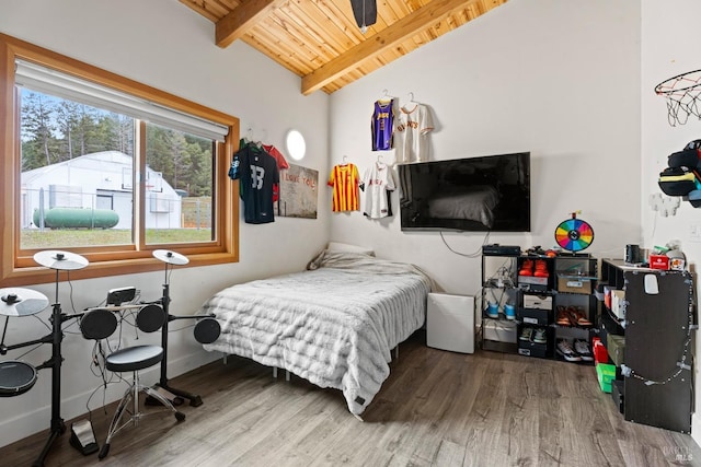 bedroom with lofted ceiling with beams, wooden ceiling, baseboards, and wood finished floors