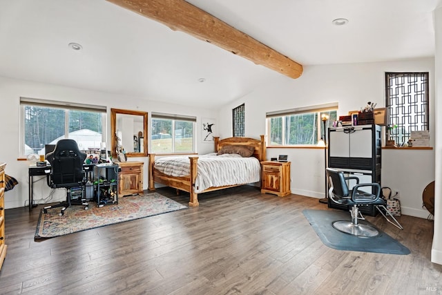 bedroom featuring lofted ceiling with beams, multiple windows, and wood finished floors