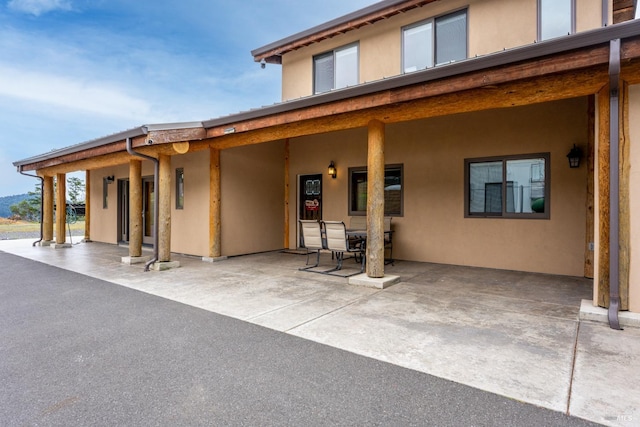 exterior space with a patio area and stucco siding