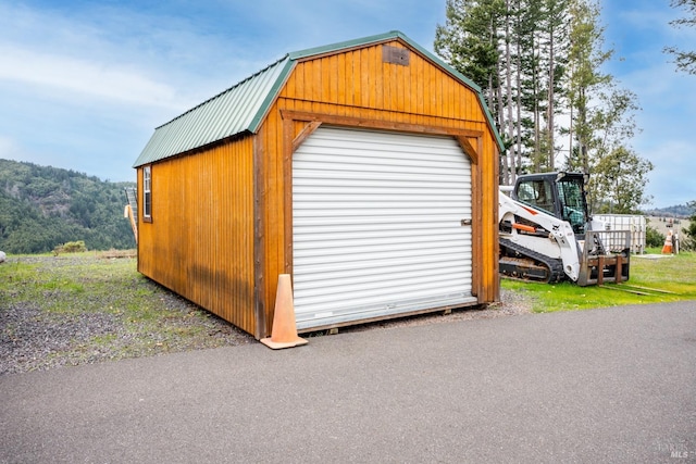 view of outbuilding with a mountain view and an outdoor structure