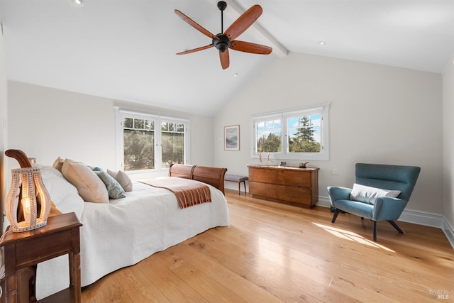 bedroom with high vaulted ceiling, light wood-style floors, baseboards, and beam ceiling