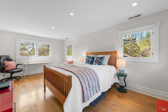 bedroom featuring baseboards, visible vents, hardwood / wood-style floors, and recessed lighting