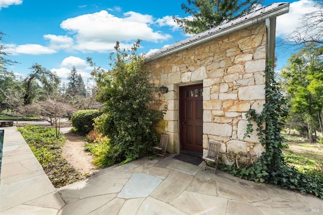 view of exterior entry featuring stone siding