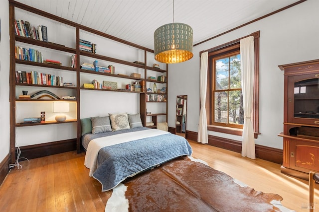 bedroom with wooden ceiling, wood-type flooring, a chandelier, and baseboards