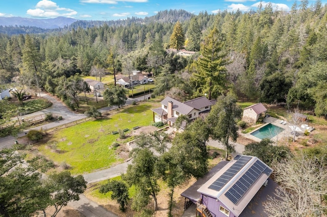 drone / aerial view featuring a forest view