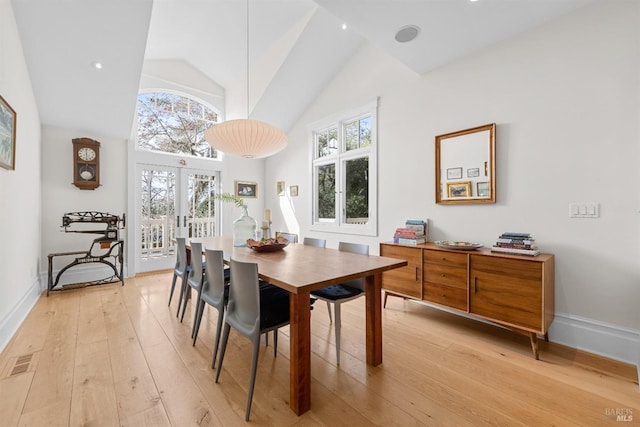 dining room featuring light wood-style floors, baseboards, visible vents, and french doors