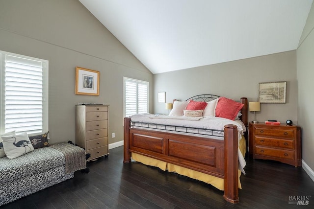 bedroom featuring dark wood-style flooring, vaulted ceiling, and baseboards