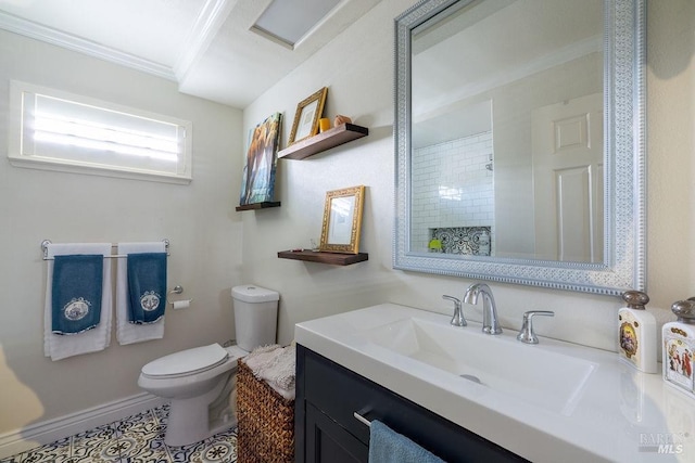 bathroom featuring toilet, crown molding, and vanity