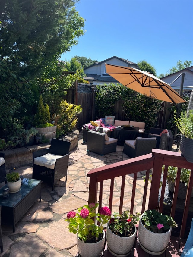 view of patio / terrace featuring fence and outdoor lounge area