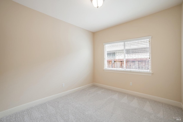 empty room with carpet and baseboards