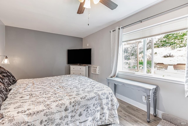 bedroom featuring light wood-type flooring, ceiling fan, and baseboards