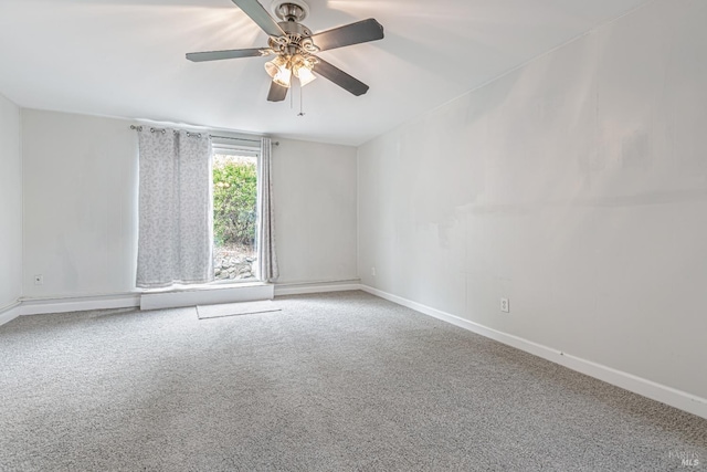 empty room featuring ceiling fan, carpet floors, and baseboards