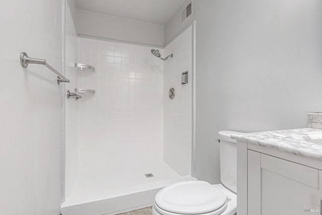 full bathroom with toilet, a stall shower, visible vents, and vanity