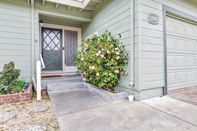 view of exterior entry with a garage