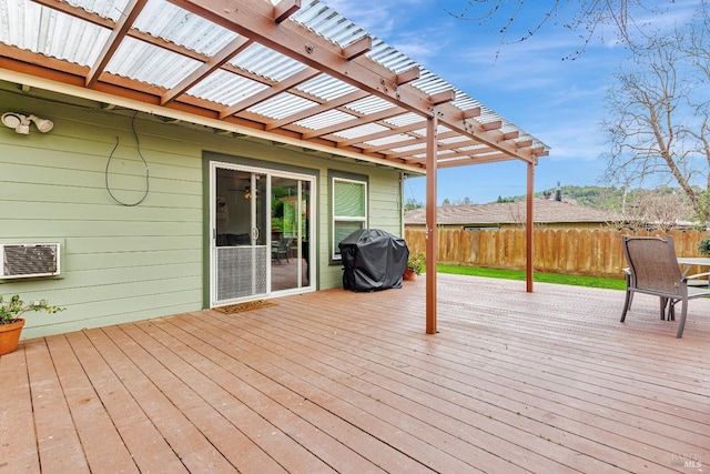 wooden terrace featuring a grill, fence, a pergola, and an AC wall unit