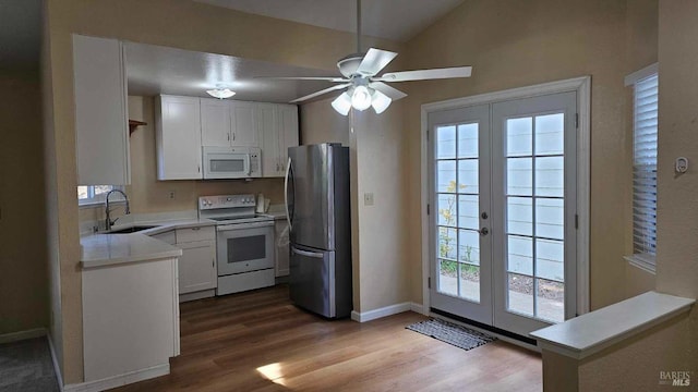 kitchen with white appliances, light countertops, a sink, and french doors